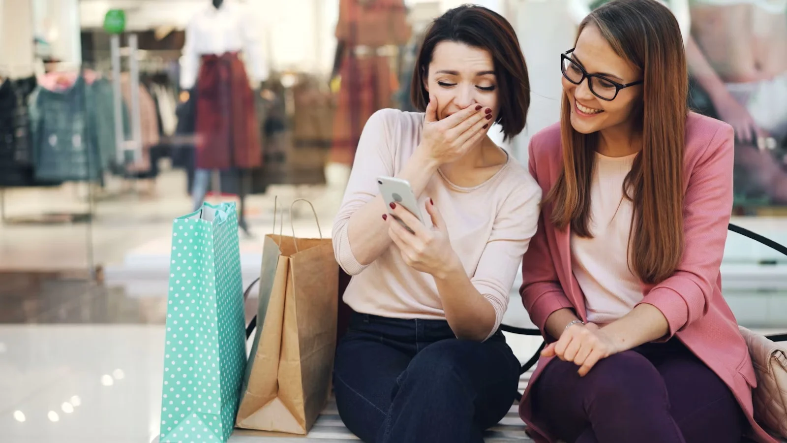 Two people happily shopping on a phone